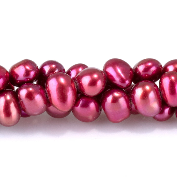 This is a Dakota Stones 5-6mm Freshwater Pearl Pink Red Flat Gemstone strand with irregular oval beads in 15-16 inch strand.