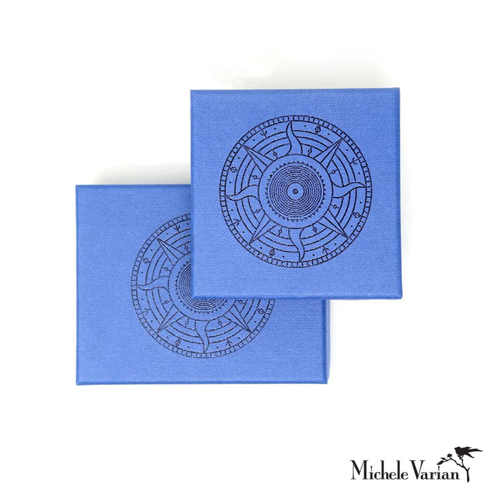 Two blue boxes with black circular designs on a white background