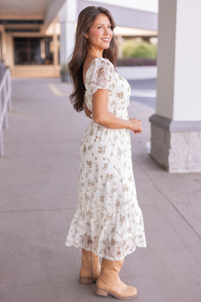 Women's cream midi dress with mustard and olive floral print sheer overlay by Blu Pepper showing full side view