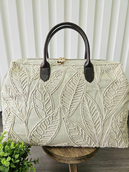 Carpet bag with leaf design.