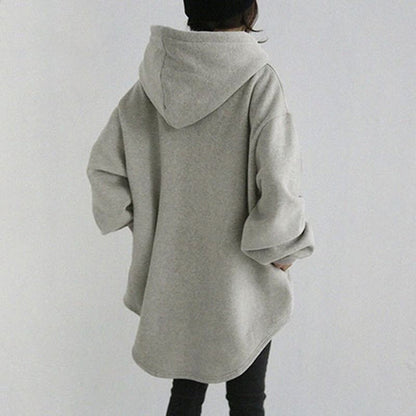 Women's longline hoodie shown in side profile with extended hem, relaxed shape and hood profile for outfit styling reference.