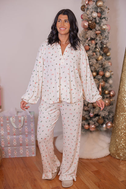 Women's cream pointelle knit pajamas with red, pink and green holly and bow tie print by Peach Love California