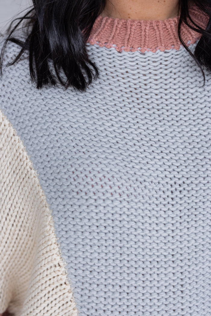 Women's dusty rose and light blue knit colorblock sweater by Wishlist showing close look at knit texture