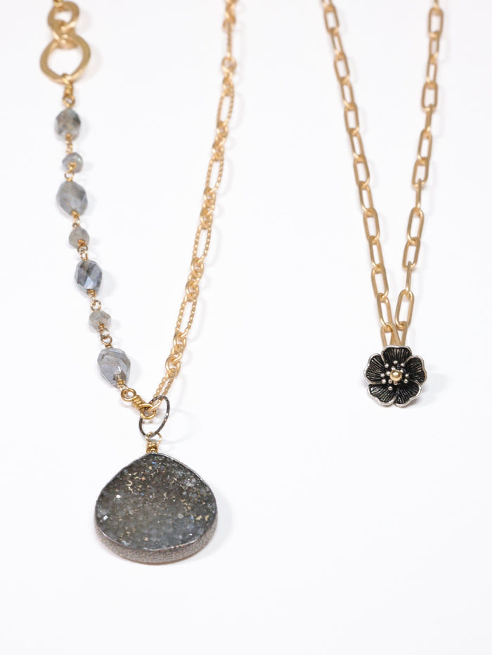Two necklaces with different pendants on a white background