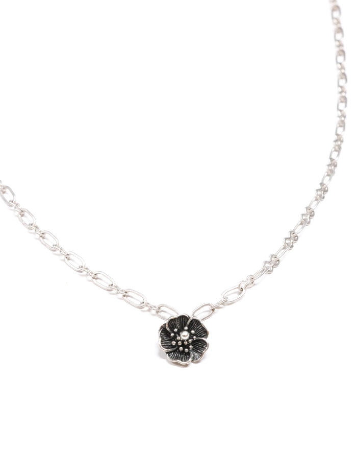 Close-up of a silver necklace with a five-petal flower pendant and dual-link chain – Five Fold Bloom Necklace in antiqued silver
