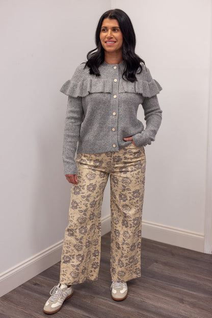 Women's grey knit sweater with a ruffle across the front chest and back shoulders by Wishlist showing full front view