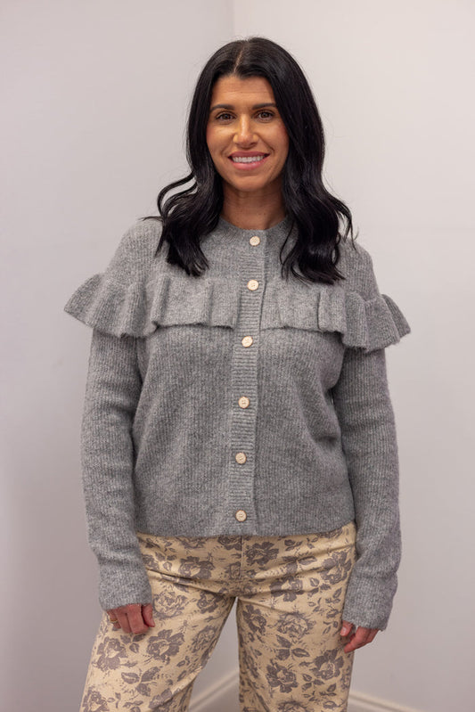 Women's grey knit sweater with a ruffle across the front chest and back shoulders by Wishlist