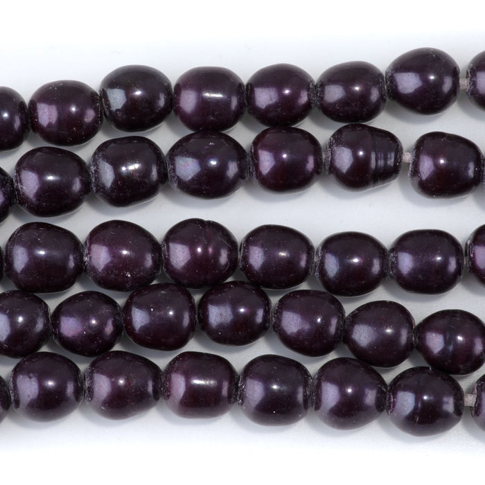 This is a Dakota Stones 10-12mm Freshwater Pearl Purple Rice Large Gemstone strand of round beads in 8 inch strand.