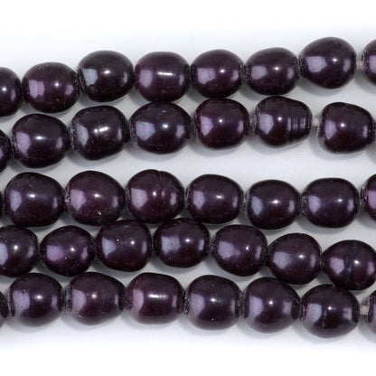 This is a Dakota Stones 10-12mm Freshwater Pearl Purple Rice Large Gemstone strand of round beads in 8 inch strand.