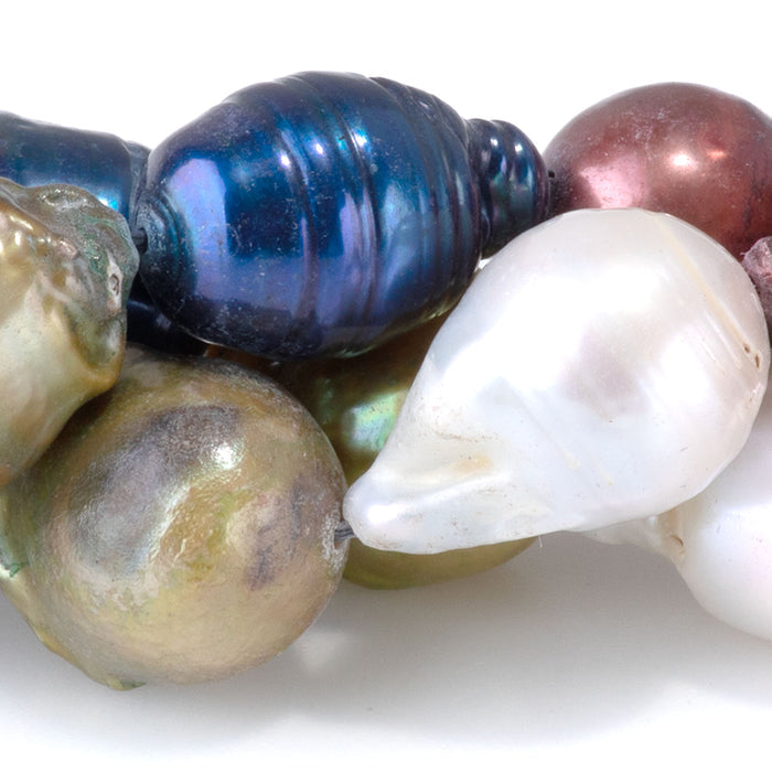 This is a Dakota Stones 12x10-15mm Freshwater Pearl Color Mix Baroque Gemstone strand of round beads in 15-16 inch strand.