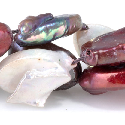 This is a Dakota Stones 14x15-17mm Freshwater Pearl Color Mix Flat Gemstone strand with oval beads in 15-16 inch strand.