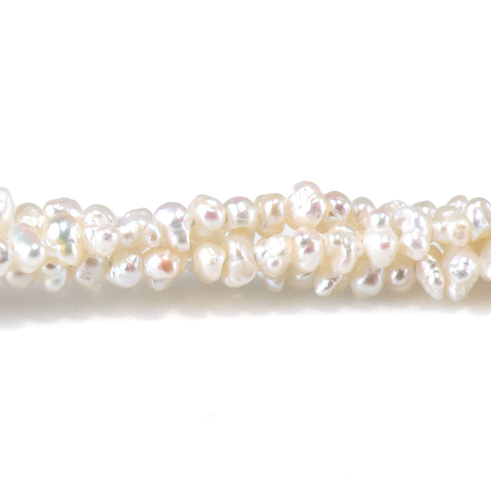 This is a Dakota Stones 3mm Freshwater Pearl White Cispy Potato Gemstone strand of round beads in 15-16 inch strand.
