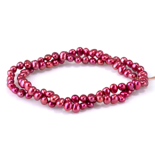 This is a Dakota Stones 5-6mm Freshwater Pearl Pink Red Flat Gemstone strand with irregular oval beads in 15-16 inch strand.