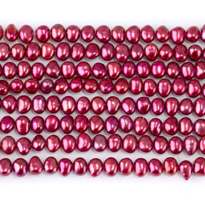 This is a Dakota Stones 5-6mm Freshwater Pearl Pink Red Flat Gemstone strand with irregular oval beads in 15-16 inch strand.