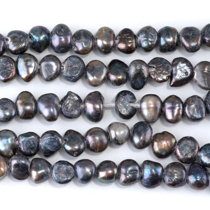 This is a Dakota Stones 6-10mm Freshwater Pearl Grey Peacock Button Gemstone strand with irregular beads in 8 inch strand.