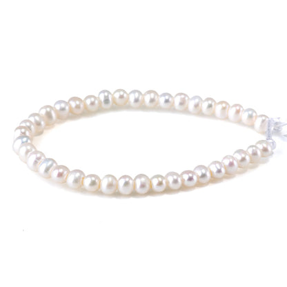 This is a Dakota Stones 6-7mm Freshwater Pearl White Large Hole Gemstone strand with oval beads in 8 inch strand.