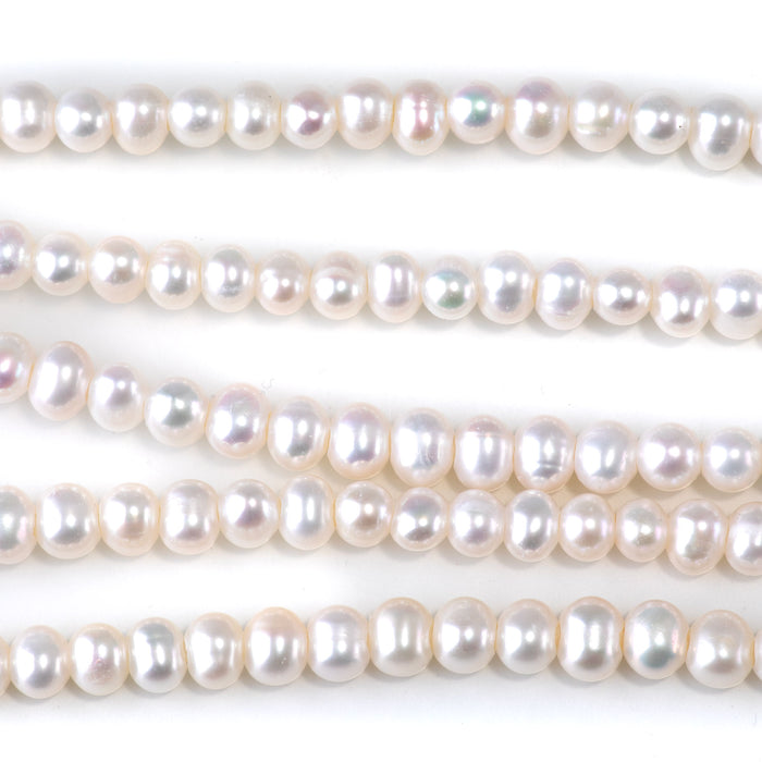 This is a Dakota Stones 6-7mm Freshwater Pearl White Large Hole Gemstone strand with oval beads in 8 inch strand.