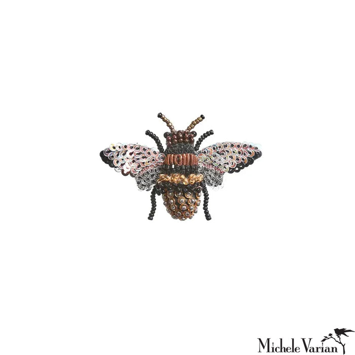 Decorative bee-shaped pin with metallic finish on a white background