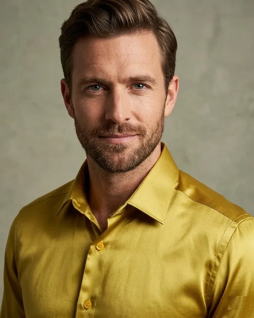 Man wearing a yellow satin shirt against a neutral background