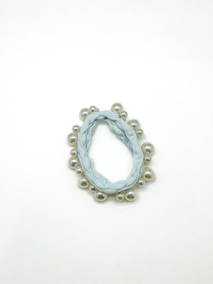 Marble-patterned earring with pearl-like beads on a white background