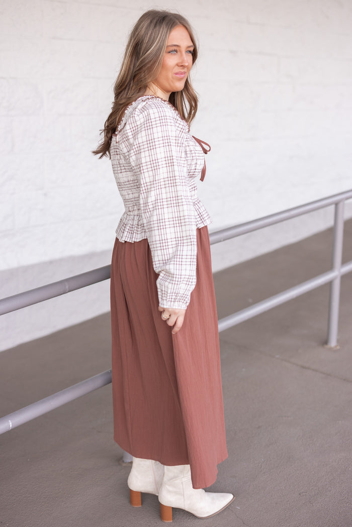 Women's ruffle detailed midi dress with smocked plaid top and solid brown skirt by In February showing side view