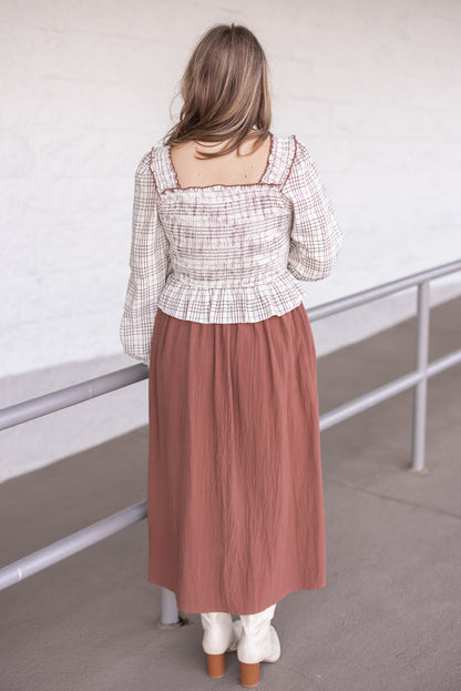 Women's ruffle detailed midi dress with smocked plaid top and solid brown skirt by In February showing back view