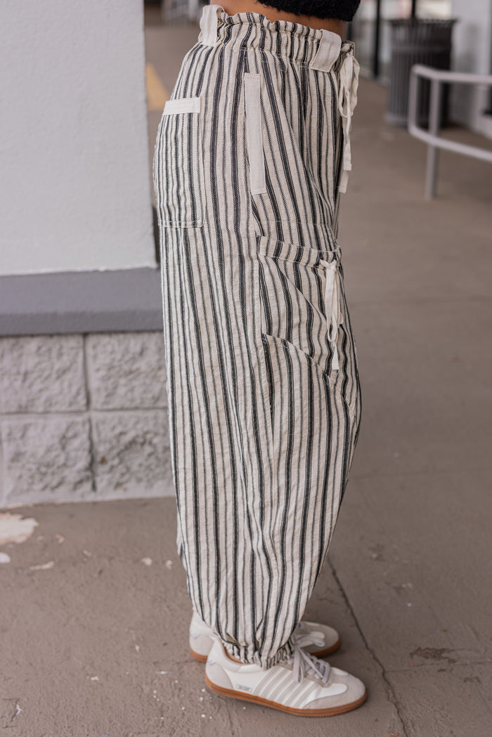 Women's oatmeal linen cargo jogger pants with black stripes by ee:some showing side view