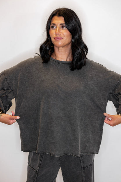 Women's mineral washed black slub top with ruffle trimmed sleeves by Easel showing relaxed silouhette
