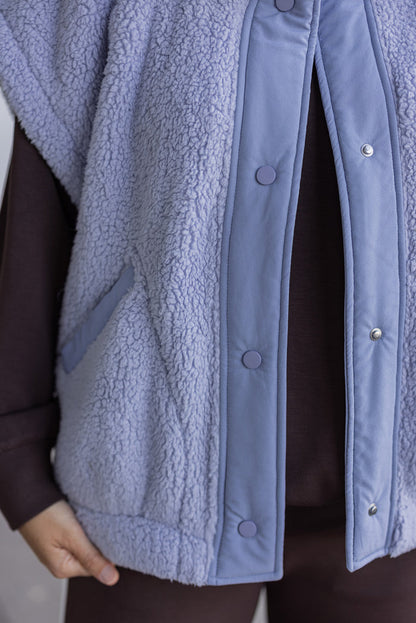 Women's light blue sherpa vest by Rae Mode showing up close of button closures