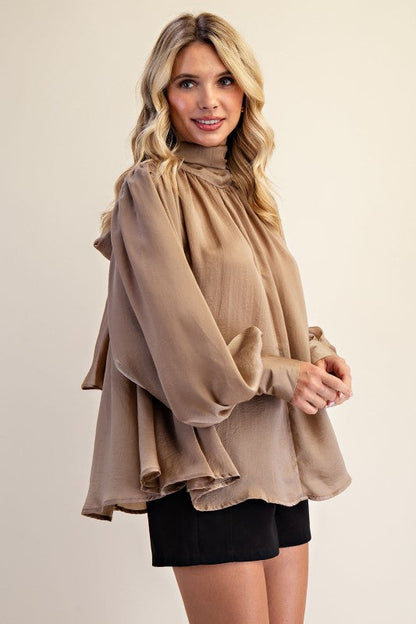 Women's taupe shimmering satin mock neck top with bow tie back showing side view