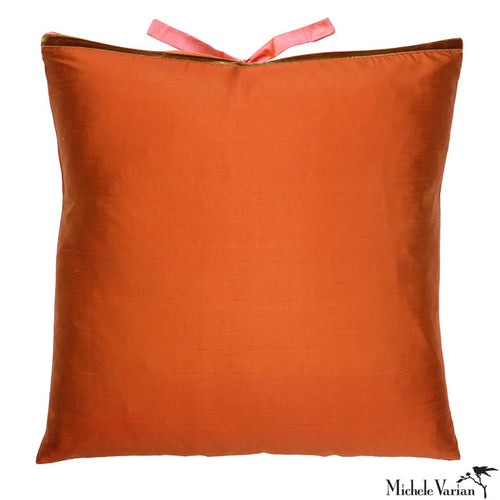 Orange silk pillow with a pink silk closure on a white background. Designed by Michele Varian.