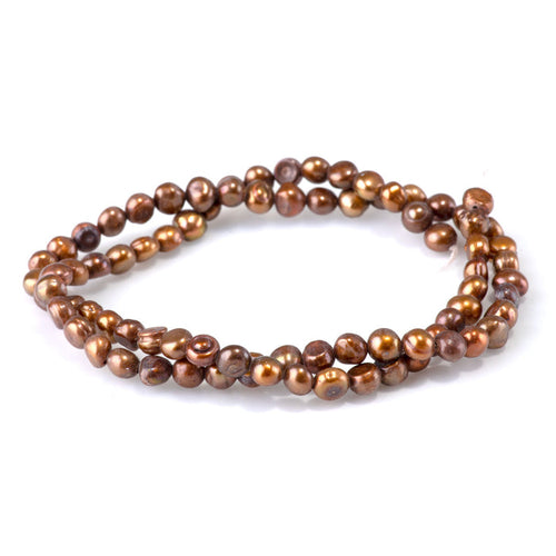 This is a Dakota Stones 5-6mm Special Price Freshwater Pearl Golden Gemstone strand with irregular beads in 15-16 inch strand.