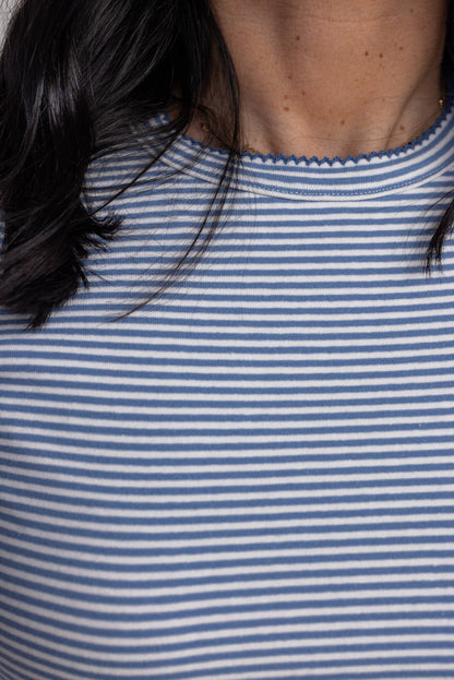 Women's blue and white striped knit long sleeve top by Wishlist showing scalloped trim on crew neckline