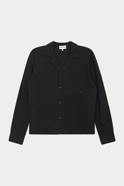 A long-sleeved black woven shirt with a revere collar, oversized chest pocket, and pearl branded button fastening.