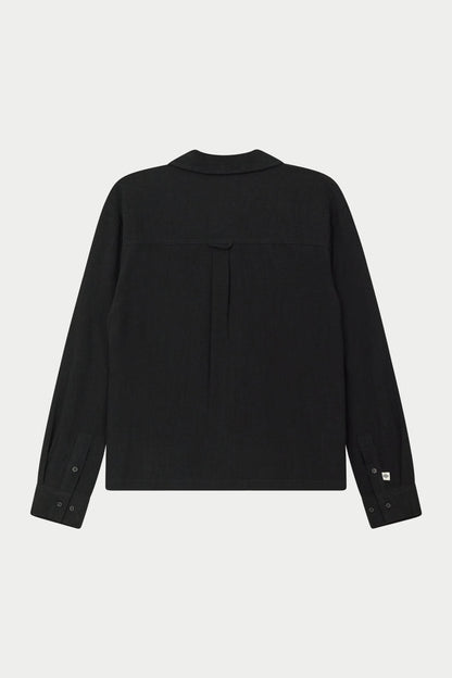 Back image of a long-sleeved black woven long sleeve shirt with a revere collar against a white background.