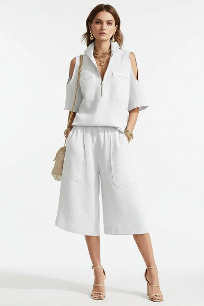 Model stands in a soft neutral studio, styled in the matching summer two-piece with 3D pockets