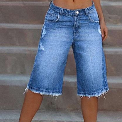 Angled shot of distressed denim shorts styled for a casual summer outfit