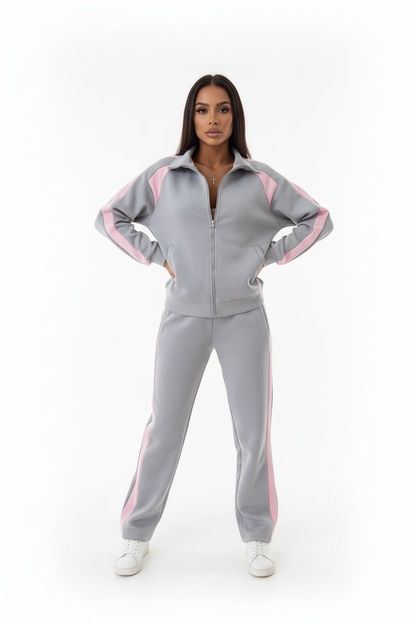 Model wearing pink zip-up tracksuit set at a gym entrance, sporty casual style, confident pose